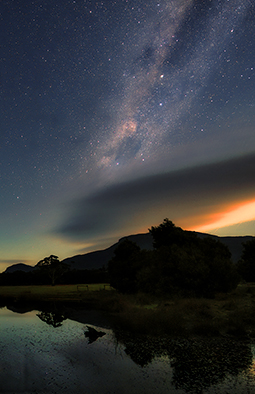 Mount William the highest mountain of the Grampians National Park and Duck Dinner Pond of Redman Bluff Wetland under the Milky Way at Grampians Paradise Camping and Caravan Parkland