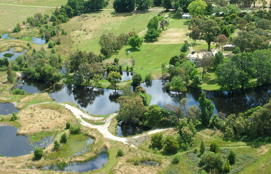 Taken form a light plane, this aerial photo shows the 30 pond Redman Bluff Wetlands forming a horseshoe of water around 3 sides Grampians Paradise Camping and Caravan Parkland Redman Bluff Wetlands at Grampians Paradadise Camping and Caravan Parkland