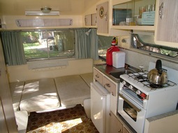 Table let down to make double bed in Kookaburra, our 1960's retro onsite caravan at Grampians Paradise Camping and Caravan Parkland