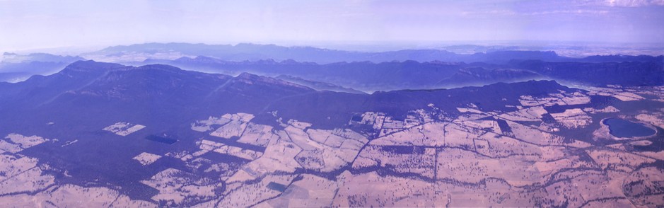 From high up in a light plane, looking down on Grampians Ranges from the east , this view of Grampians National Park centres on Grampians Paradise Camping and Caravan Parkland. Photo by Aidan Banfield